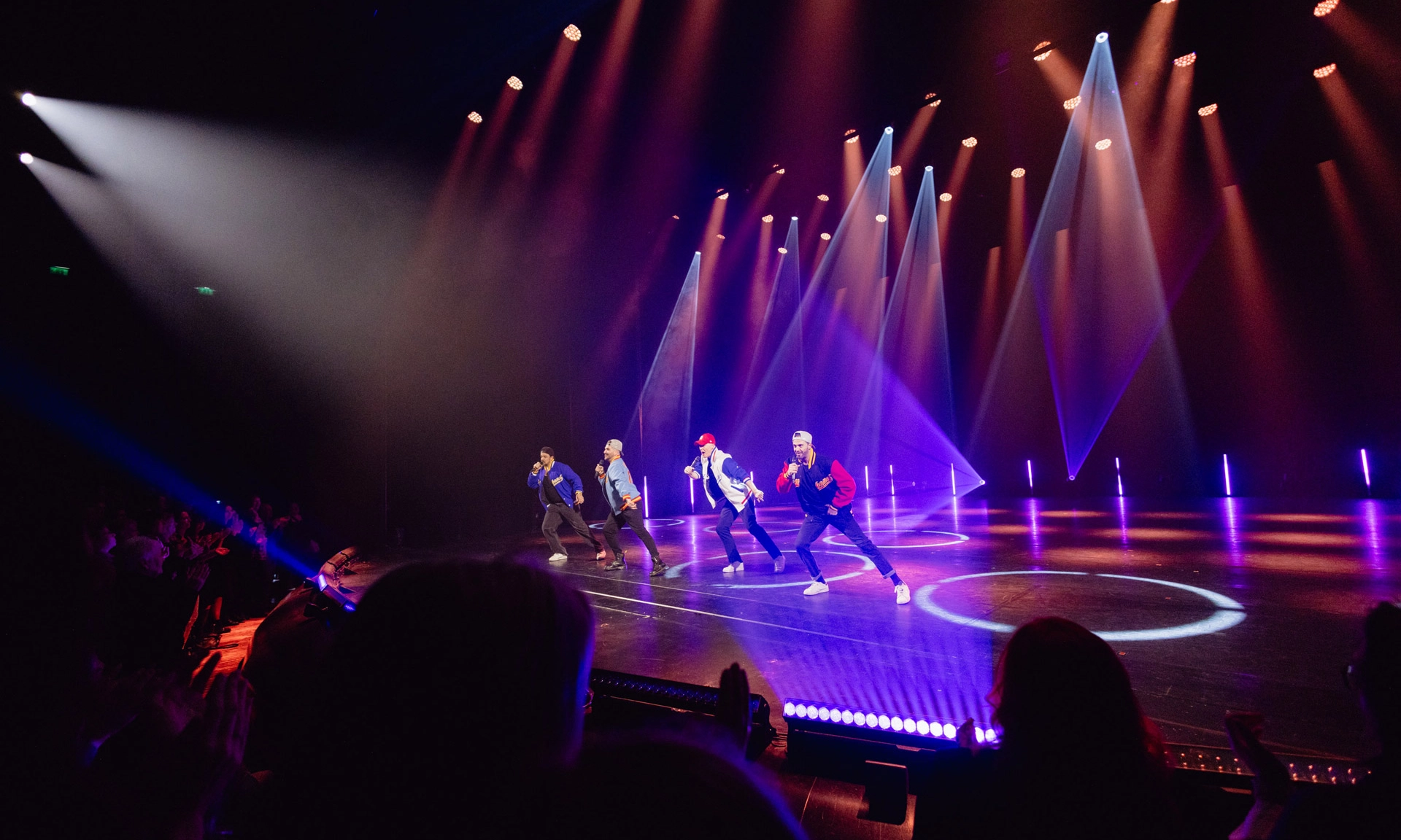Tanzgruppe auf Bühne mit bunten Lichtern