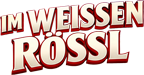 Logo „Im weißen Rössl“ vor Sonnenuntergangshimmel